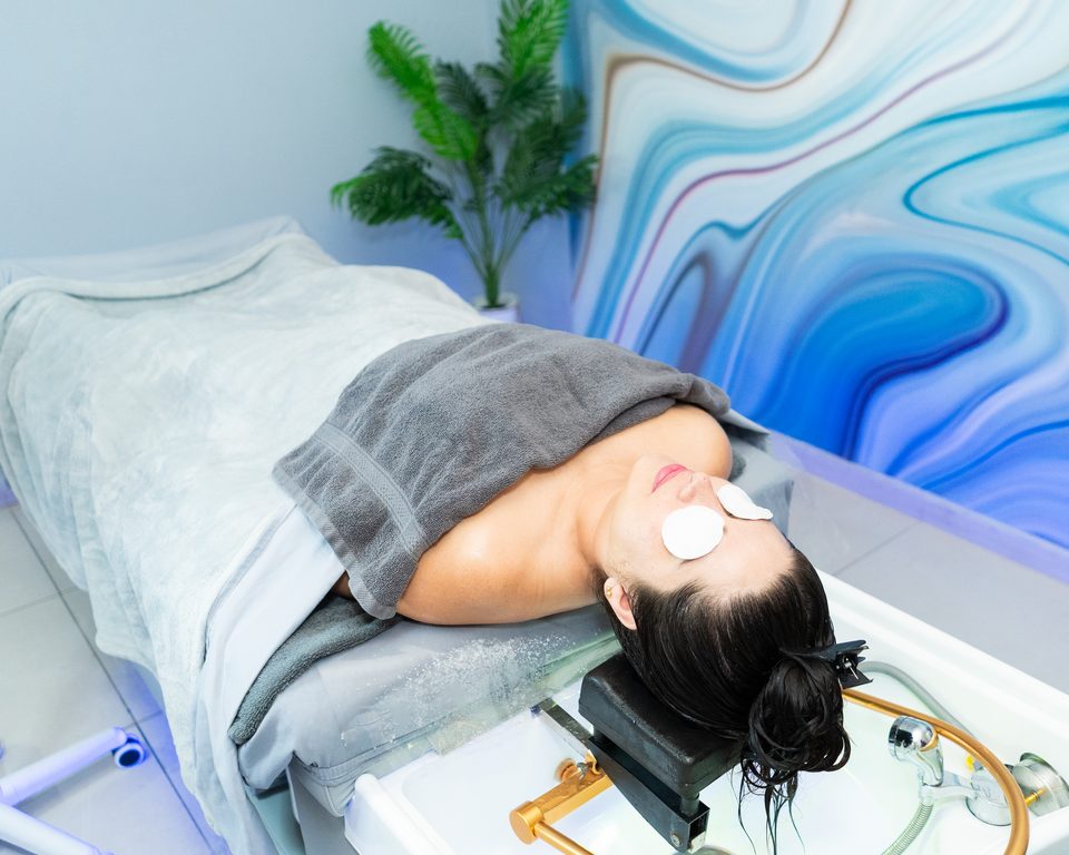 Guest resting with a warm towel during the scalp phase of a head spa ritual.
